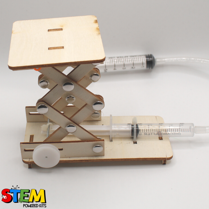Angled view of the Hydraulic Lift STEM Kit, illustrating the functionality of the syringes and tubing in raising and lowering the lift platform