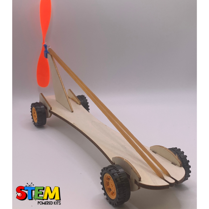 Side view of the fully assembled Rubber Band Race Car STEM Kit, highlighting the propeller mechanism, elastic bands, and lightweight wooden body for interactive STEM exploration.