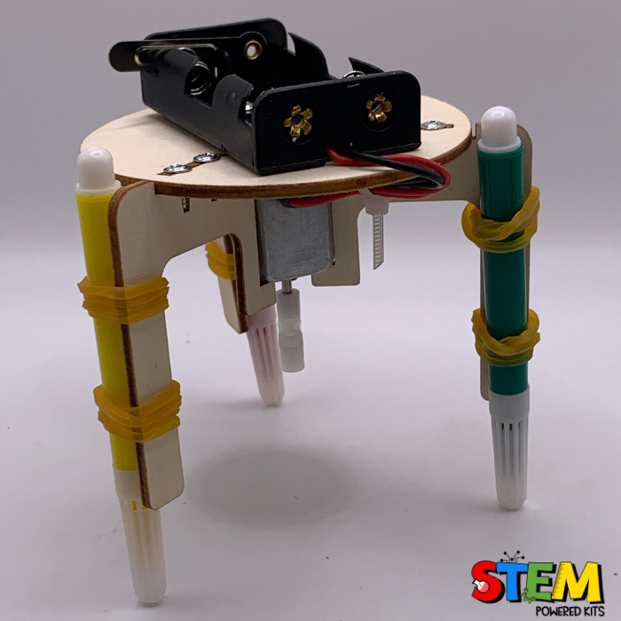 "Side view of the wooden Graffiti Robot STEM project, featuring its sturdy design with markers, rubber bands, and motorized structure for artistic fun.